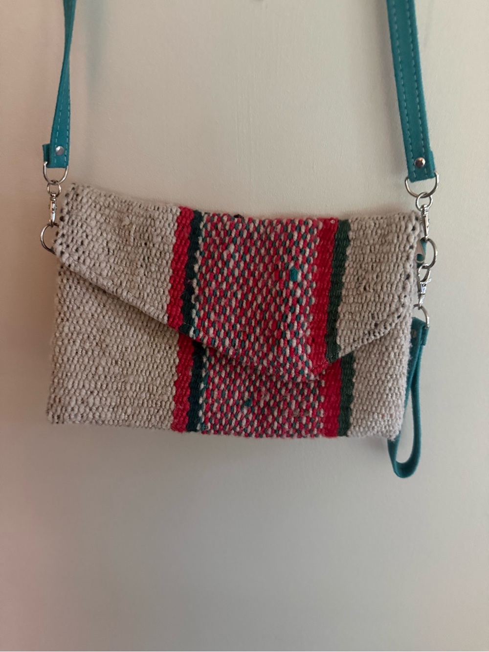 Handwoven Beige Crossbody Bag with Turquoise Strap and Red Accent